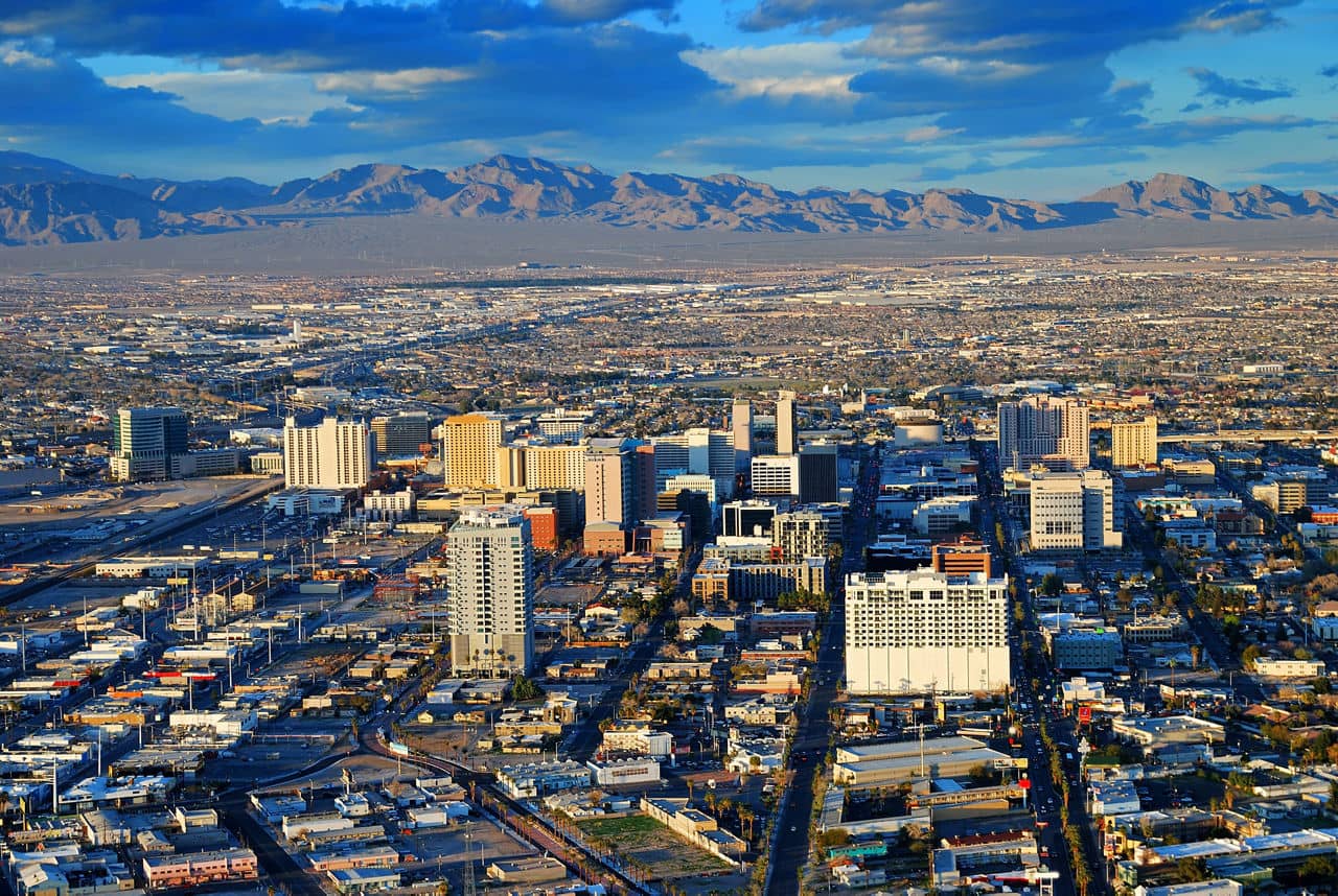 Las Vegas street Skyline aerial view with mountain and hotels on strip.