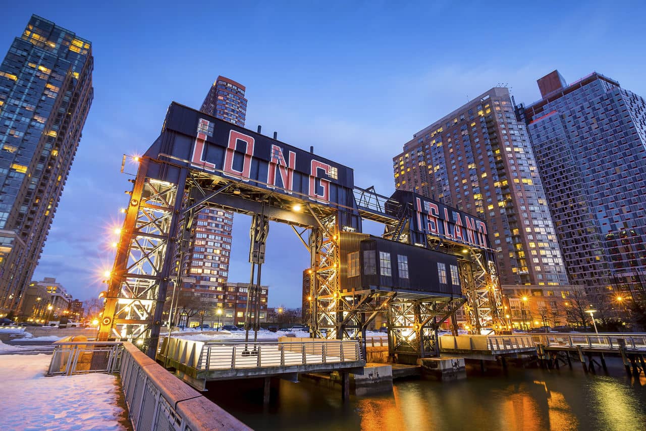 the buildings of long island in front of east river at twilight