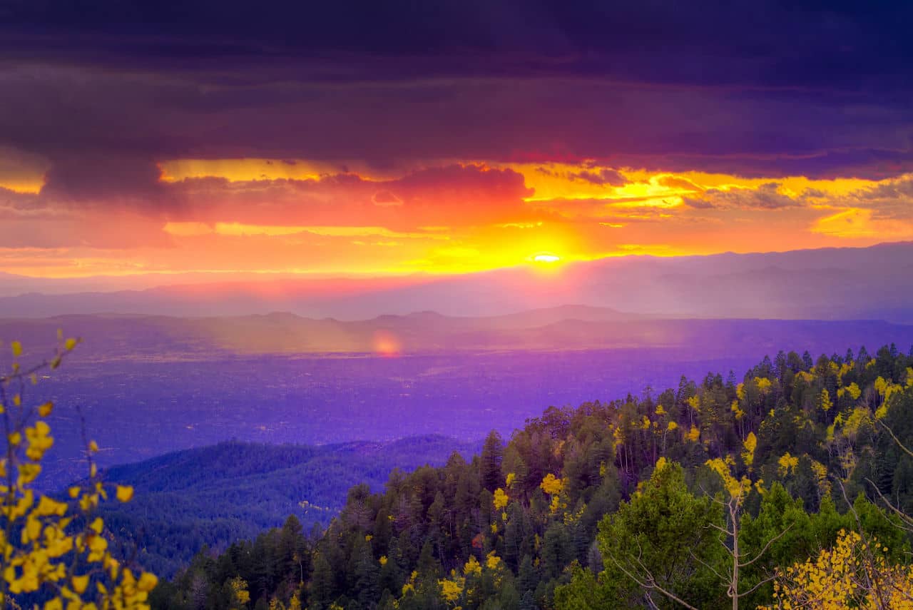 New Mexico fall mountain sunset  featuring golden aspens and rays of sunlight
