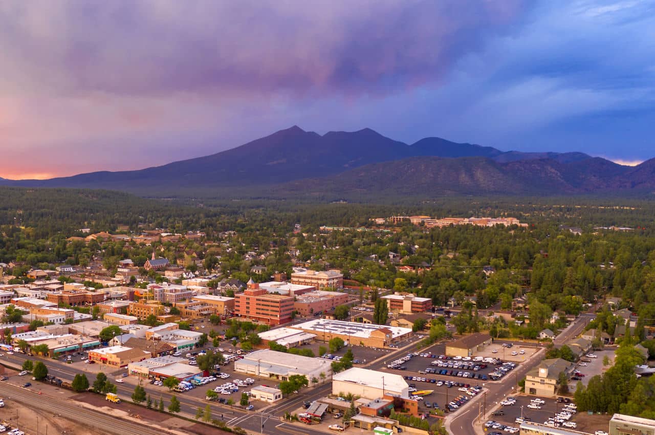 Blue and Orange color swirls around in the clouds at sunset over Flagstaff Arizona