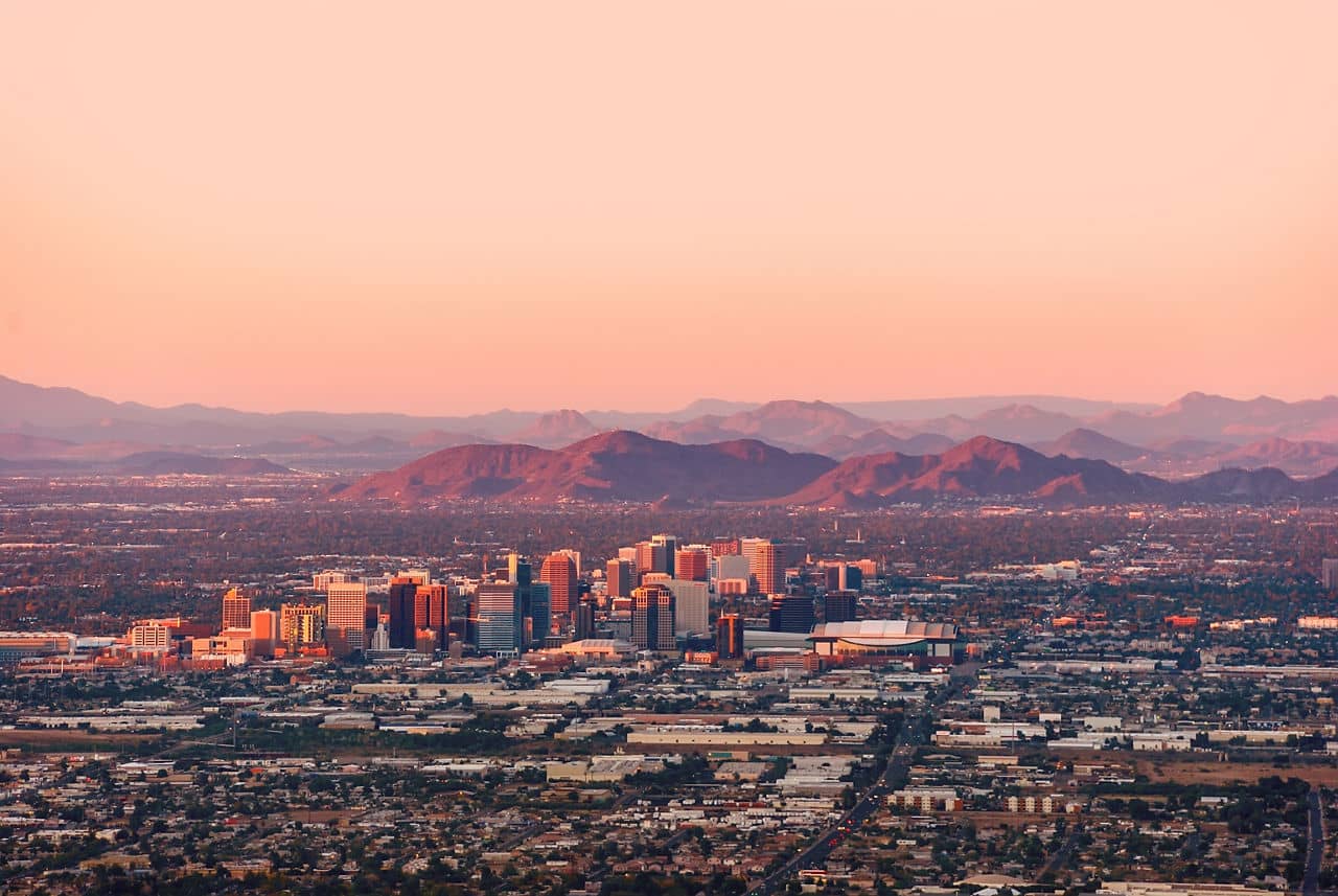 Phoenix Arizona skyline at sunset with downtown skyscrapers and mountain backdrop - aerial city view