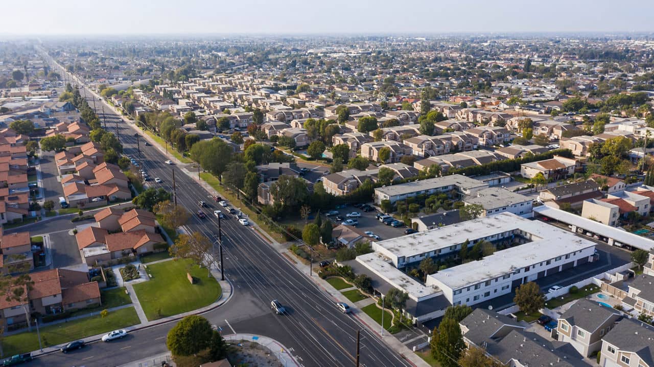 Aerial view of suburban neighborhood in Fountain Valley, California highlighting tree-lined streets. 