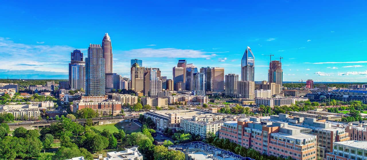 Panoramic view of Charlotte NC skyline showing uptown apartments and residential communities - North Carolina urban living