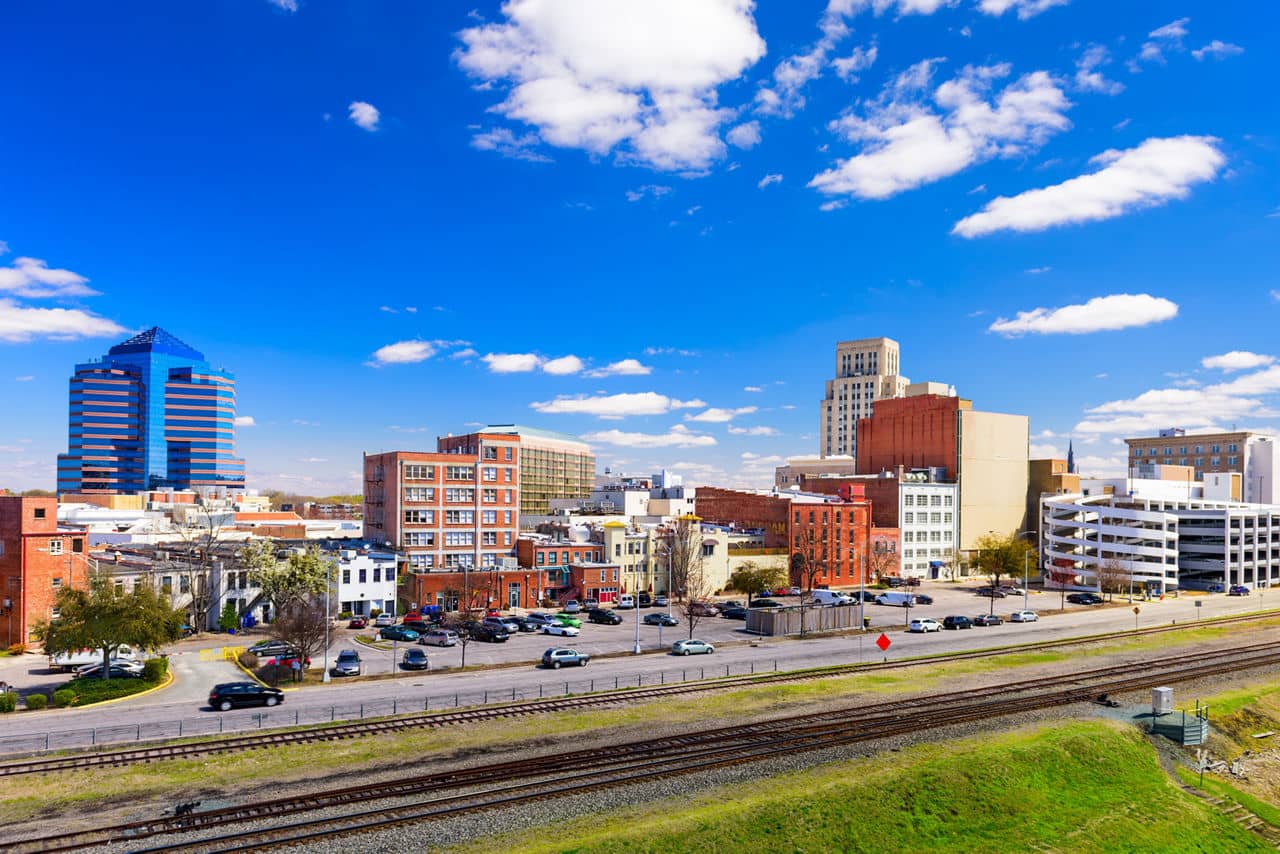Modern skyscrapers and historic brick buildings form the vibrant downtown Durham skyline, North Carolina.