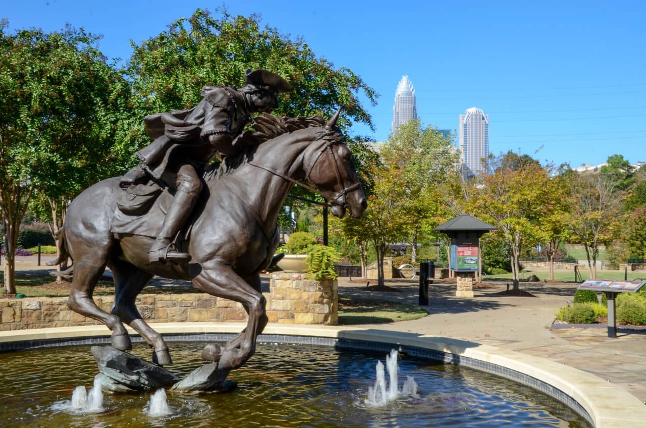 Bronze equestrian statue of Captain James Jack on a galloping horse, prominently displayed in a fountain in Charlotte, North Carolina.