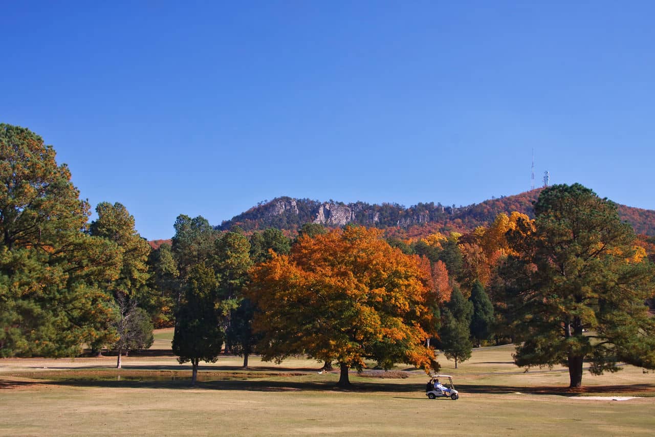 Crowders Mountain Golf Course fairway and green with vibrant autumn fall foliage, Kings Mountain, North Carolina.