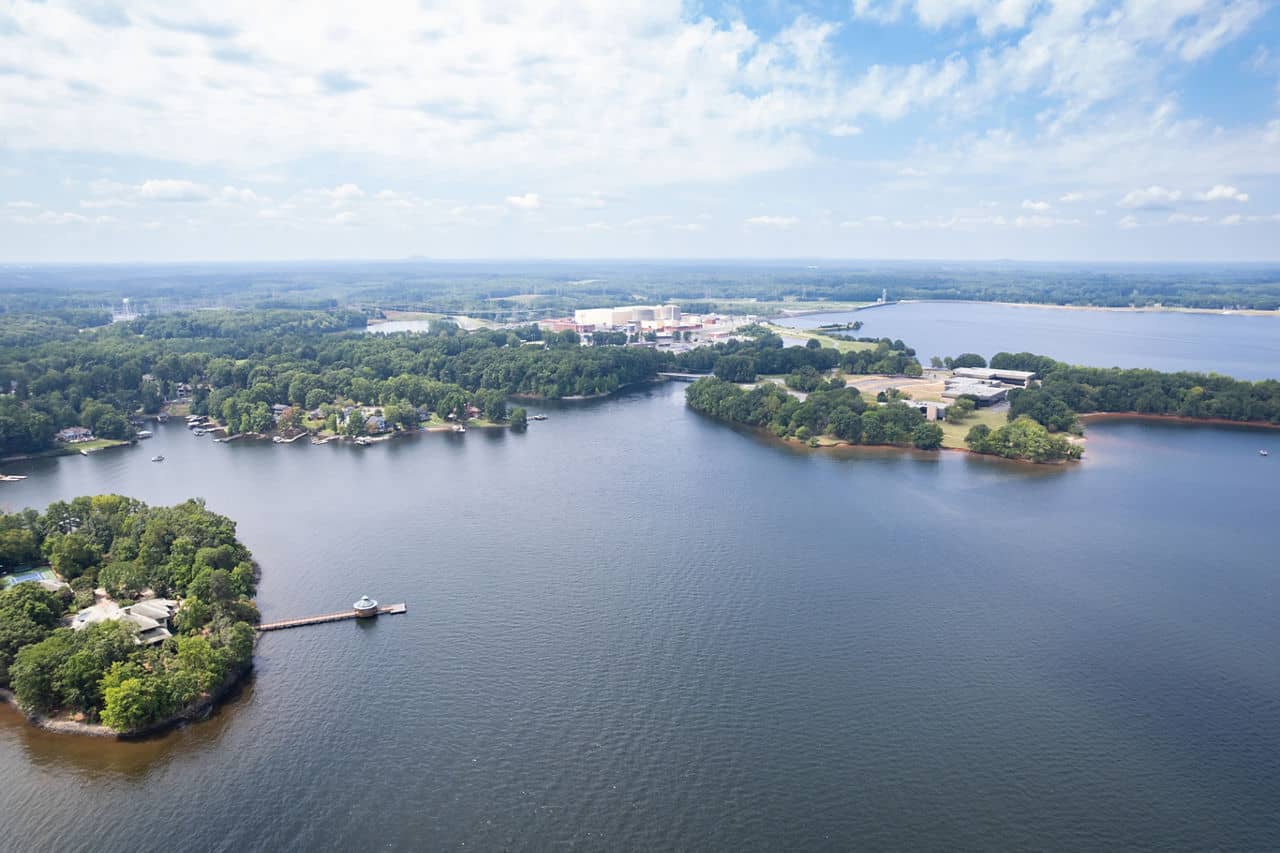 An aerial view of the serene waters of Lake Norman, featuring its tree-lined shores, located in North Carolina.