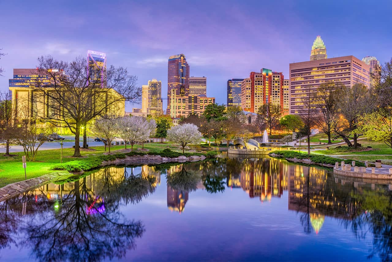 Charlotte NC skyline at dusk with park and pond - SouthPark Charlotte area North Carolina urban living