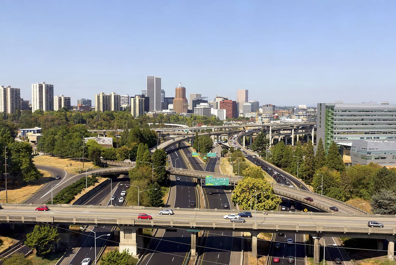 Portland Oregon downtown city skyline with traffic freeway daytime