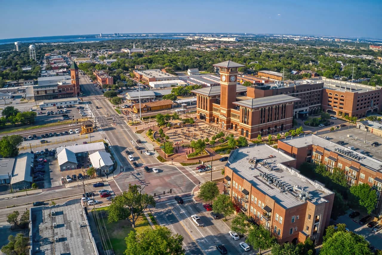Aerial view of the Keller neighborhood in Texas, featuring spacious homes and green trees under a clear blue sky.