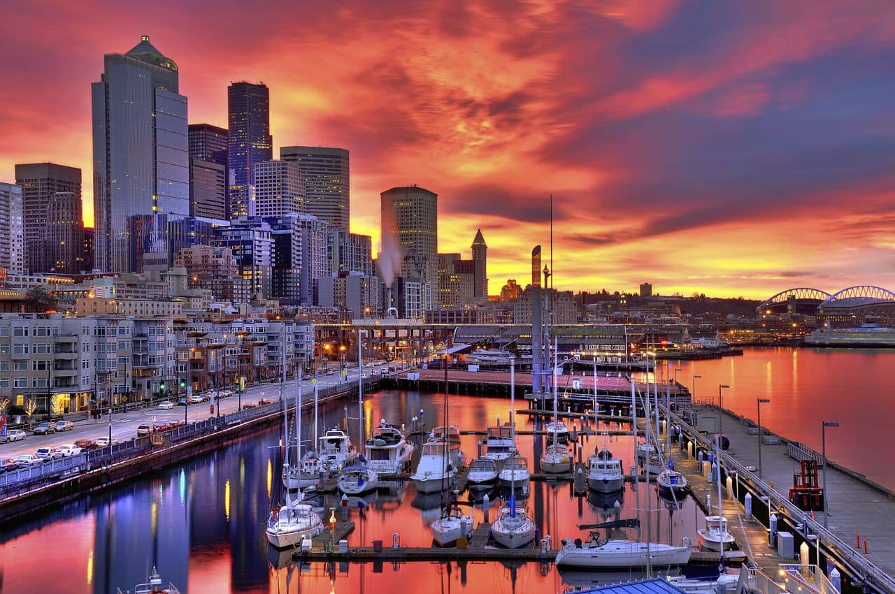 High dynamic image of Seattle skyline in dramatic sunrise colors across pier-66 waterfront