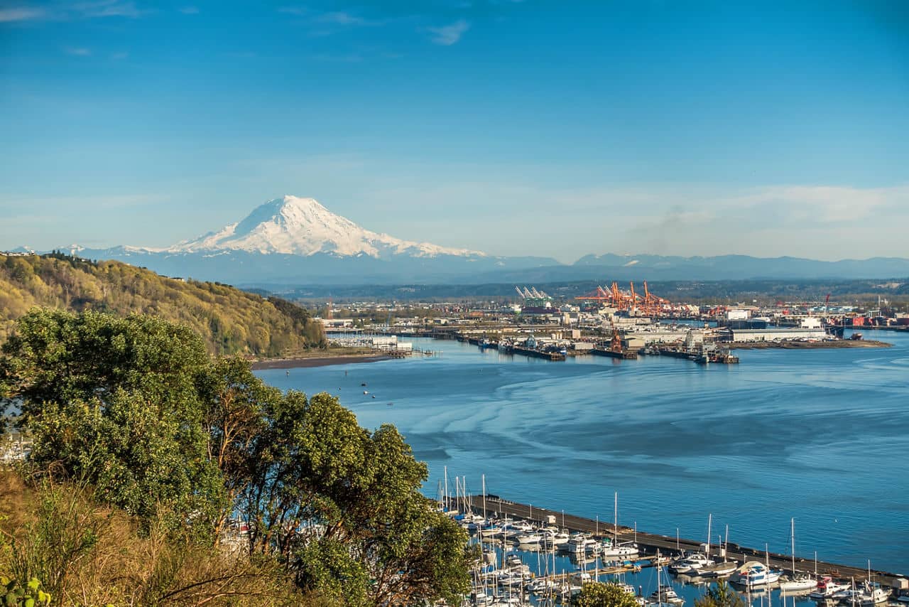 A panoramic view of Mount Rainier, The Port of Tacoma and a marina.